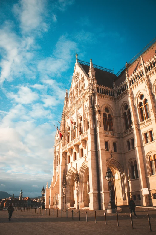 a large building with a clock tower in front of it, inspired by Mihály Munkácsy, pexels contest winner, parliament, sunny sky, thumbnail, hungarian