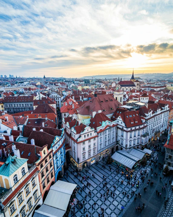 a view of a city from the top of a building, prague in the background, square, multicoloured, beautifully lit