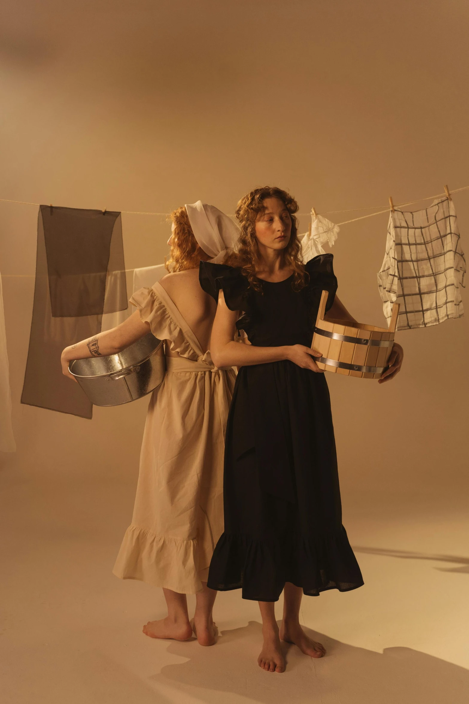 a couple of women standing next to each other, an album cover, inspired by Anna Füssli, laundry hanging, 1 9 1 0 s style, movie still 8 k, shot with sony alpha 1 camera