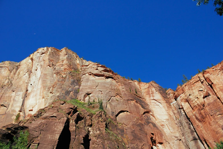 a group of people standing on top of a cliff, clear blue skies, large overhangs, utah, adam ondra