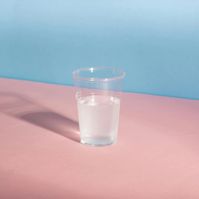 a glass of water sitting on top of a table, paper cup, detailed product image, minimalist composition, silicone skin