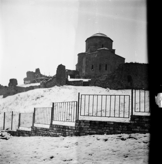 a black and white photo of a snow covered hill, graffiti, byzantine ruins, rotunda, 1959, kodak photograph