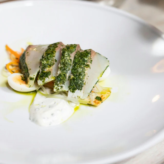 a close up of a plate of food on a table, inspired by Barthélemy Menn, abalone, basil gogos, half fish, white