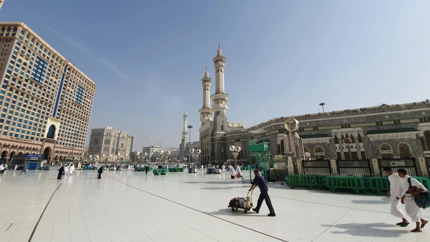 a group of people walking around a large building, a picture, hurufiyya, mecca, shot with sony alpha, in a square, ap art