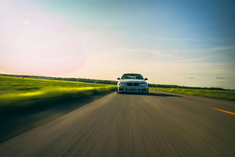 a white car driving down a country road, pexels contest winner, renaissance, bmw, ultrawide lens”, racing, lensflare