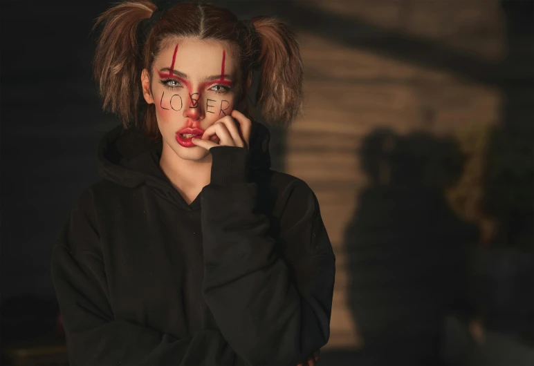 a woman with makeup and blood on her face, a character portrait, trending on pexels, graffiti, two pigtails hairstyle, in a black hoodie, doll face, girl with messy bun hairstyle