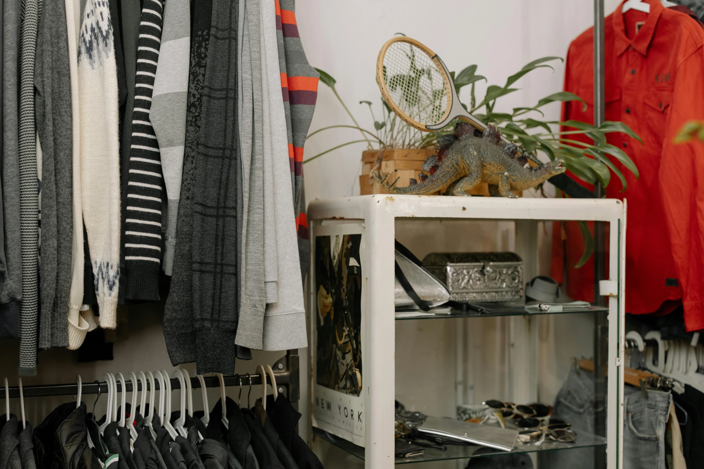 a rack of clothes in a clothing store, by Matija Jama, trending on pexels, foliage clothing, trinkets, standing on a shelf, federation clothing