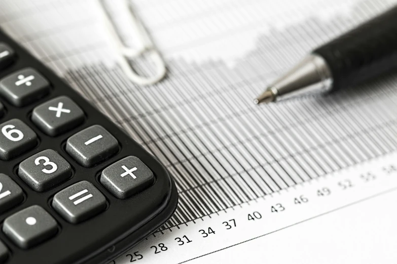 a calculator sitting on top of a piece of paper next to a pen, a detailed drawing, black-and-white, cuastics, promo image, mid closeup