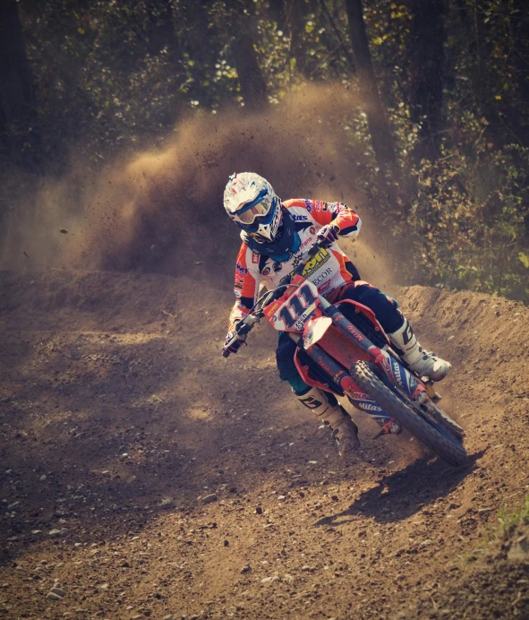 a person riding a dirt bike on a dirt track, pexels contest winner, figuration libre, orange racing stripes, college, profile image, performance