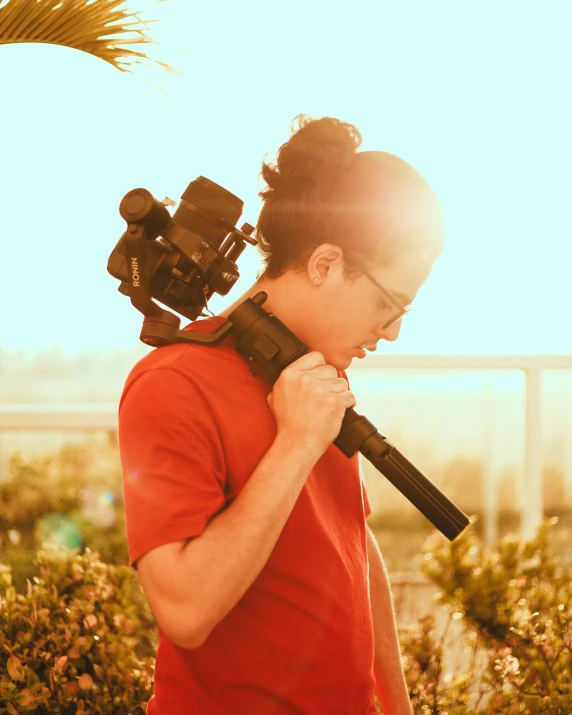 a man with a camera attached to his shoulder, unsplash, happening, rebecca sugar, golden hour 8 k, live footage, david shing