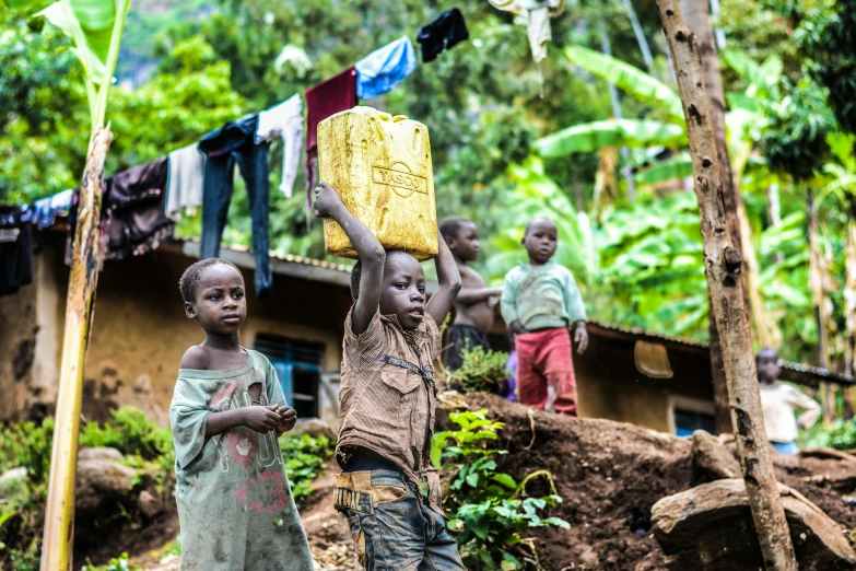 a group of children standing on top of a dirt hill, by Dietmar Damerau, pexels contest winner, mud and brick houses, avatar image, mongezi ncaphayi, people at work