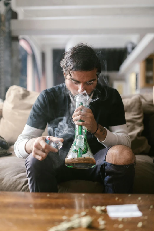 a man sitting on a couch smoking a pipe, trending on pexels, renaissance, meth lab, holding green fire, bong, ethan klein