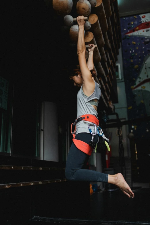 a woman that is jumping in the air with a ball, belaying, regular build, webbing, full body hero