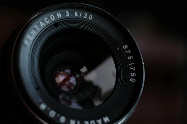 a close up of a camera lens on a table, a macro photograph, by Mathias Kollros, pexels contest winner, photorealism, medium format, 1 9 3 0 s -'4 0 s baltar lenses, medium format. soft light, 35mm of a very cute