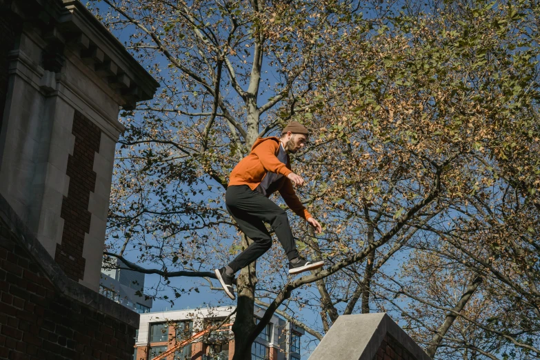 a man flying through the air while riding a skateboard, by Lee Loughridge, unsplash, parkour, autumnal, live-action archival footage, full frame image