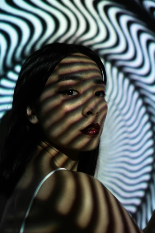 a woman that is standing in front of a mirror, inspired by Gao Cen, pexels contest winner, abstract illusionism, lsd waves, unreal engine : : rave makeup, young asian woman, opart