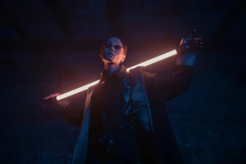 a man with a sword in his hand, cyberpunk art, unsplash, bauhaus, he is casting a lighting spell, film promotional still, androgynous vampire, human glowing