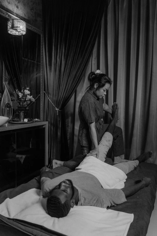 a black and white photo of a man getting a massage, by Carrie Mae Weems, massurrealism, set on singaporean aesthetic, lofi, ✨🕌🌙, anders petersen