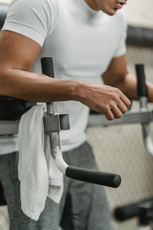 a man working out on a machine in a gym, pexels contest winner, bandage on arms, half turned around, dingy, promo image