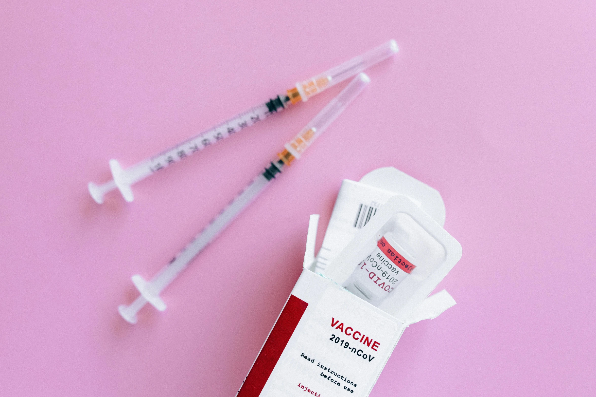 a couple of syops sitting on top of a pink surface, unsplash, holding syringe, white and red color scheme, detailed product shot, medical labels