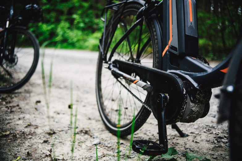 a bicycle parked on the side of a dirt road, by Kristian Zahrtmann, mechanical details, electric, tourist photo, close up shot from the side