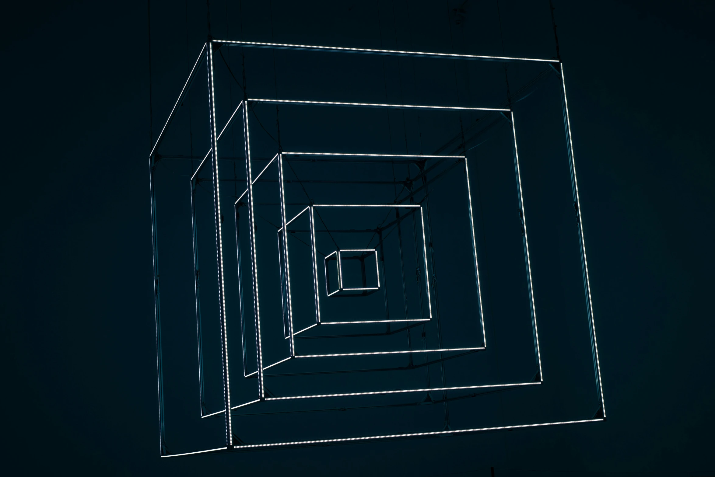 a black and white photo of a square structure, an album cover, inspired by Richard Anuszkiewicz, unsplash, computer art, dark blue neon light, ignant, magicavoxel, ultra detailed wire decoration