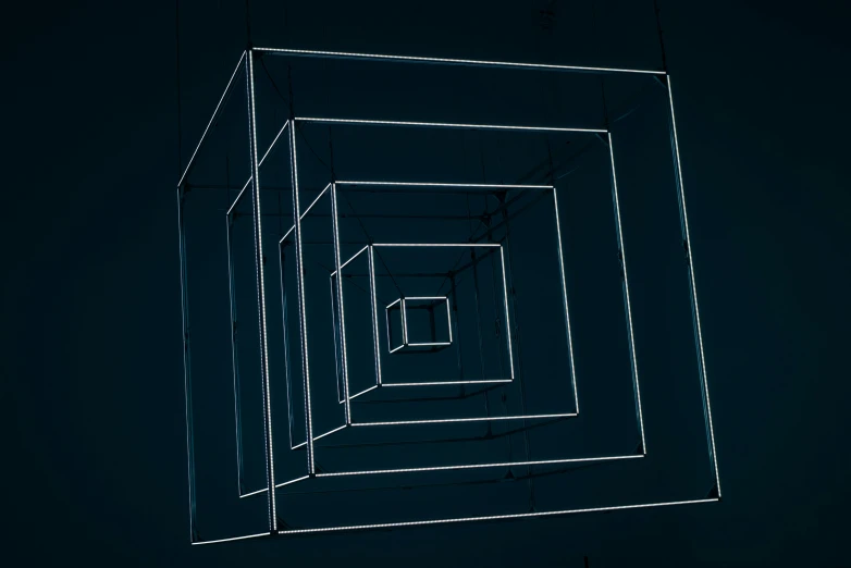 a black and white photo of a square structure, an album cover, inspired by Richard Anuszkiewicz, unsplash, computer art, dark blue neon light, ignant, magicavoxel, ultra detailed wire decoration