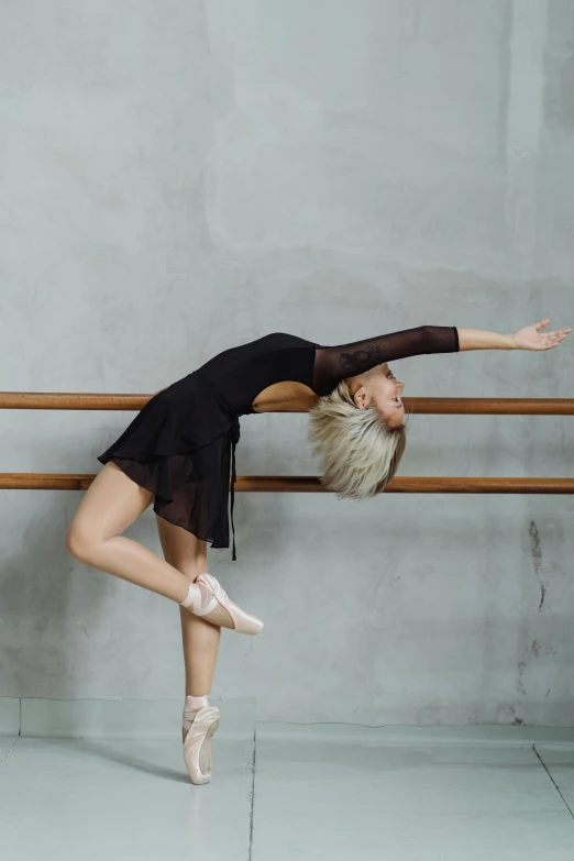 a woman in a black leo leo leo leo leo leo leo leo leo leo leo leo leo, inspired by Elizabeth Polunin, pexels contest winner, arabesque, standing sideways, sydney hanson, square, anna nikonova aka newmilky