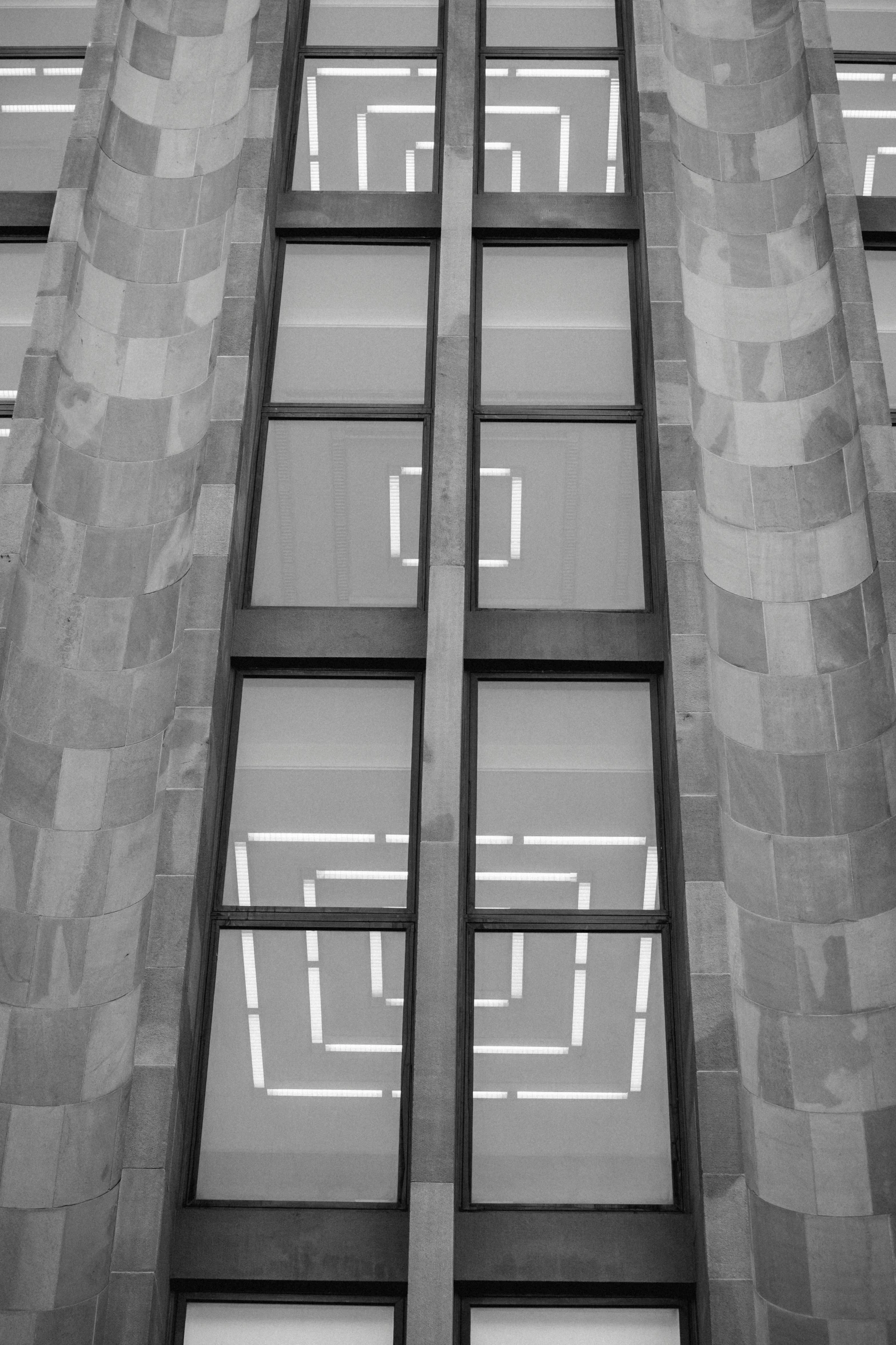 a black and white photo of a tall building, a black and white photo, unsplash, berlin secession, window lighting, library, squares, square shapes