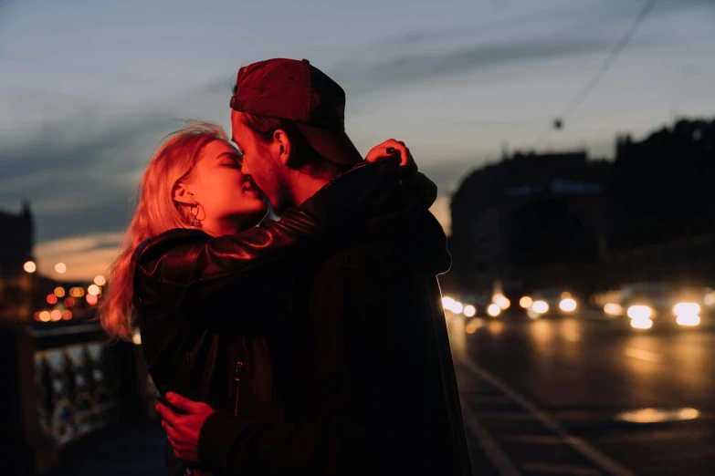 a man and woman kissing on a bridge at night, trending on pexels, standing in a city street, bisexual lighting, sweet hugs, profile image