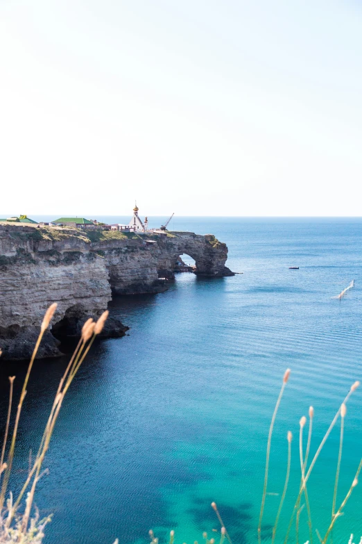 a large body of water next to a cliff, by Alexis Grimou, apulia, slide show, torri gate, hziulquoigmnzhah