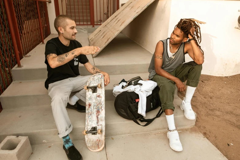 a couple of men sitting next to each other with skateboards, a portrait, by Everett Warner, pexels contest winner, ashteroth, talking, promotional image, lightly dressed