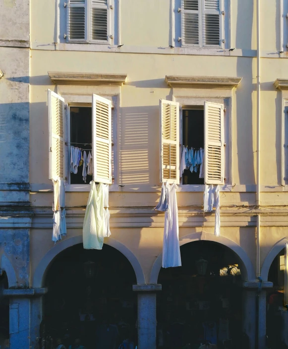 a building with clothes hanging out of the windows, whitewashed buildings, pasta, no cropping, uncropped