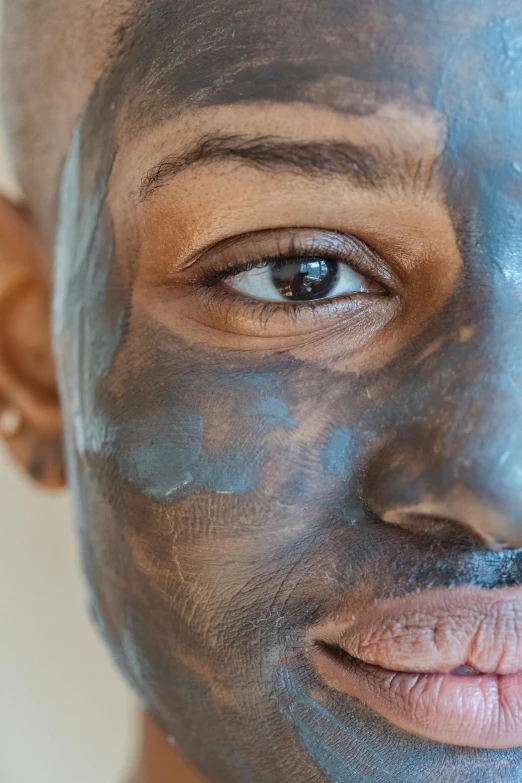 a close up of a person with a face mask, trending on pexels, renaissance, charcoal color skin, smooth blue skin, lean man with light tan skin, ebony skin