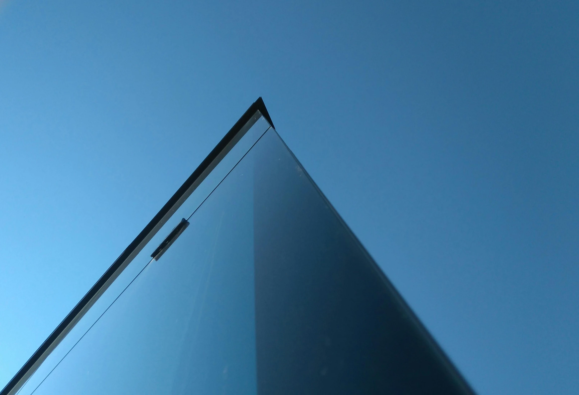 a tall glass building with a blue sky in the background, inspired by Tadao Ando, pexels contest winner, minimalism, micro detail 4k, transparent black windshield, angular minimalism, ultra minimalistic