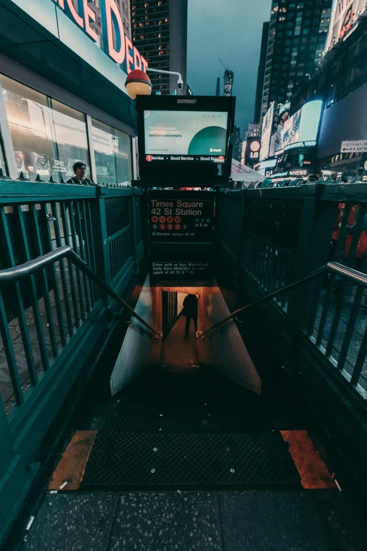 a person walking down an escalator in the middle of a city, inspired by Elsa Bleda, unsplash contest winner, happening, post-apocalyptic times square, digital displays, dark train tunnel entrance, dark city bus stop