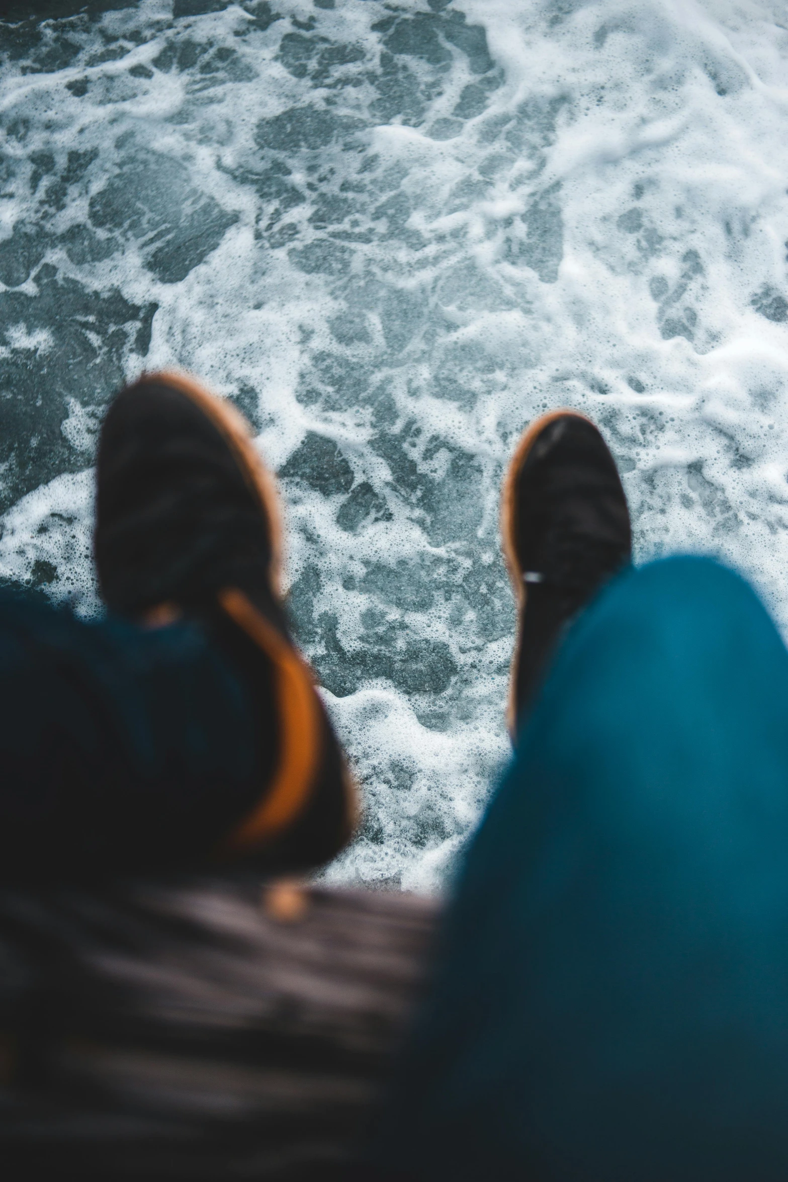 a person standing on top of a boat in the ocean, trending on unsplash, happening, sitting on the floor, close-up on legs, ocean waves, high quality image”