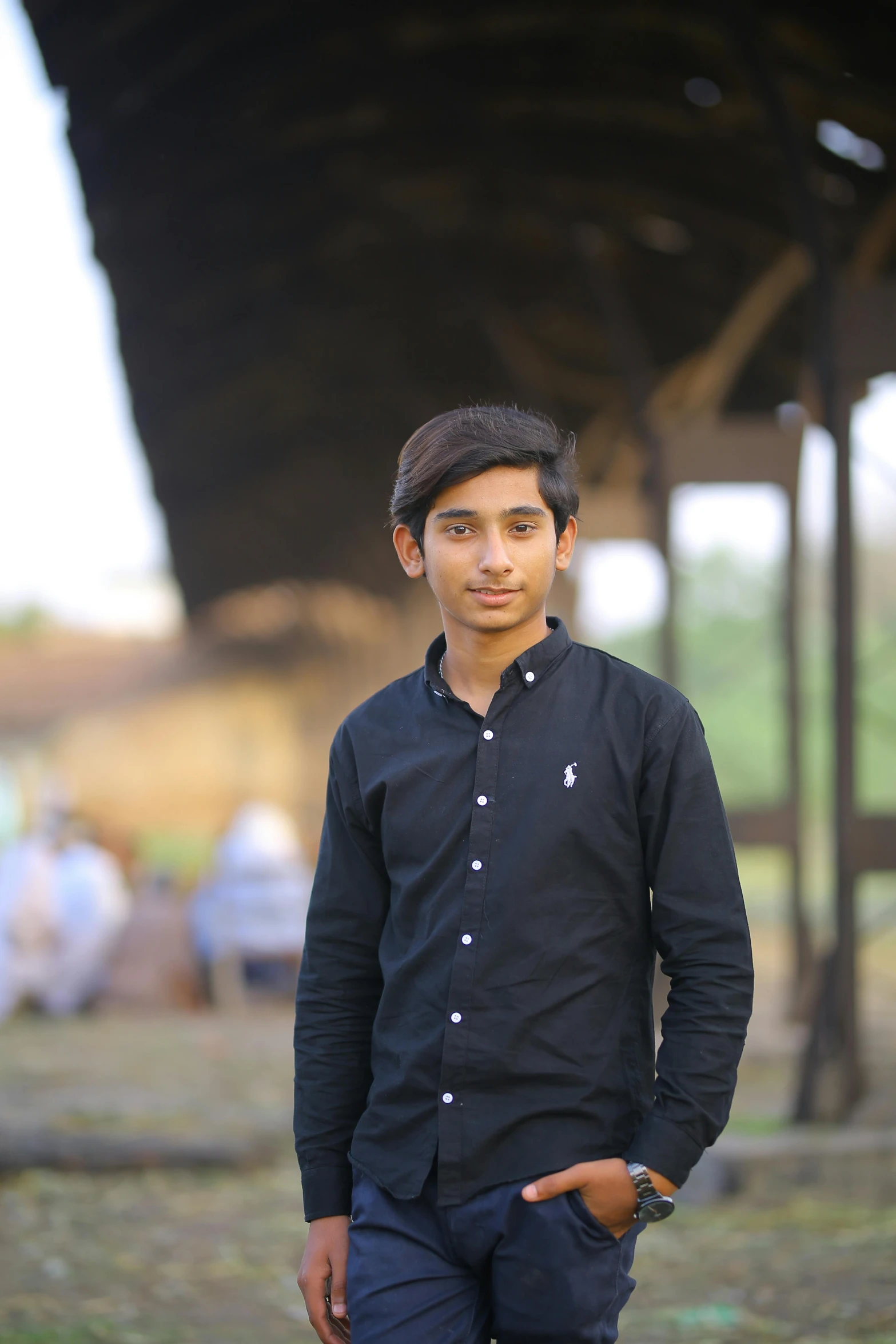 a man standing with his hands in his pockets, by Riza Abbasi, pexels contest winner, realism, male teenager, headshot profile picture, wearing a black shirt, standing in an arena