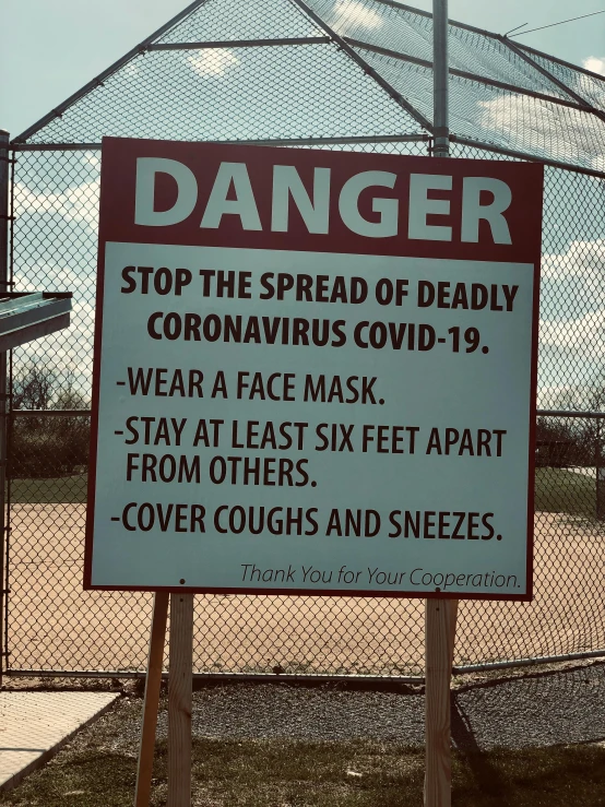 a sign that reads danger stop the spread of deadly coronavirus covidid - 19 wear a face mask stay at least six feet apart from, a photo, by Bernie D’Andrea, pexels, graffiti, at a skate park, il, 😭🤮 💔, photo taken in 2018