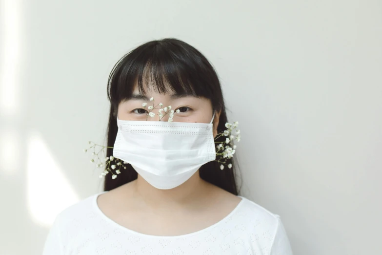 a close up of a person wearing a face mask, a picture, by Ayami Kojima, pexels contest winner, in front of white back drop, 中 元 节, teenager girl, clean medical environment