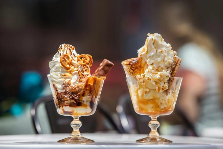 a couple of ice cream sundaes sitting on top of a table, profile image, caramel, caulfield, close up photograph