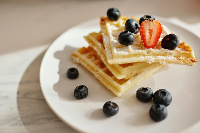 a white plate topped with waffles and blueberries, by Niko Henrichon, pexels contest winner, squares, 15081959 21121991 01012000 4k, natural morning light, thumbnail