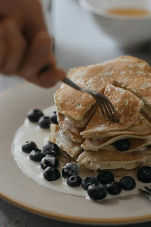 a white plate topped with pancakes and blueberries, trending on unsplash, cinematic still, blond, cooking, gif