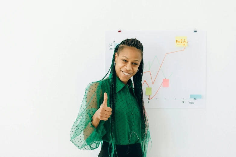 a woman standing in front of a whiteboard giving a thumbs up, trending on unsplash, green charts, black female, with a ponytail, professional profile picture