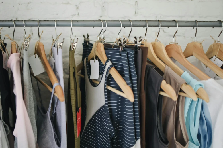 a row of clothes hanging on a rail, trending on pexels, 🦩🪐🐞👩🏻🦳, wearing a vest top, marketing photo, high quality material bssrdf