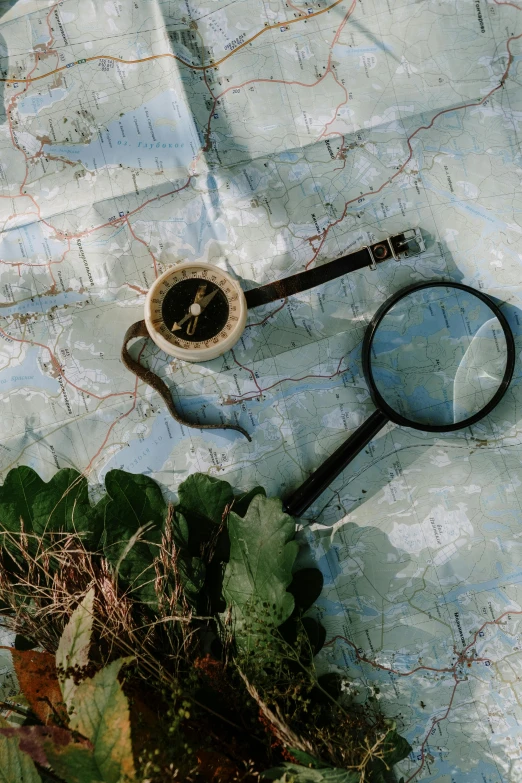 a magnifying glass sitting on top of a map, trending on unsplash, visual art, adventurer, fields, military, conde nast traveler photo