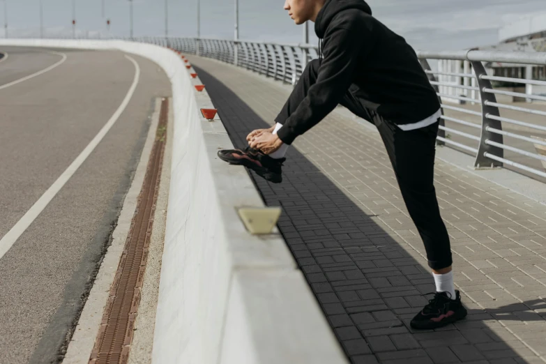 a man getting ready to run on a bridge, happening, pixel stretching, promotional shot, angled, neoprene