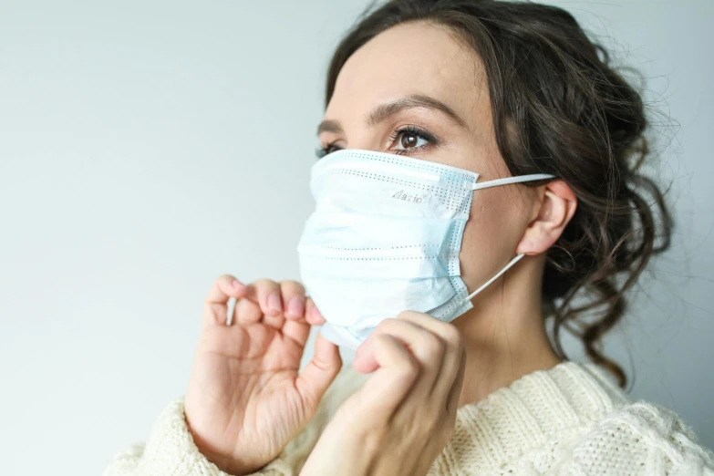 a woman putting on a surgical mask, by Adam Marczyński, pexels, plasticien, looking from side!, avatar image, decoration, thumbnail