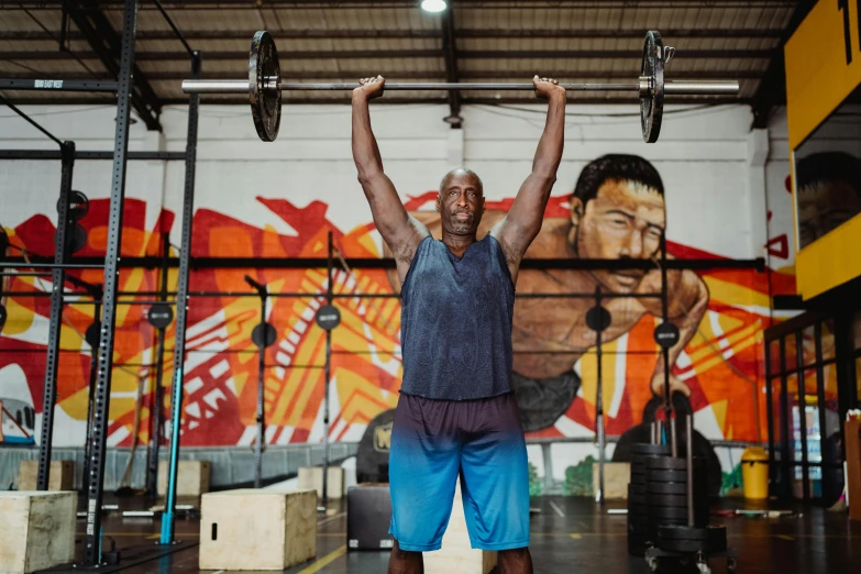 a man holding a barbell above his head in a gym, a portrait, pexels contest winner, shaq, origin jumpworks, aged 4 0, full colour