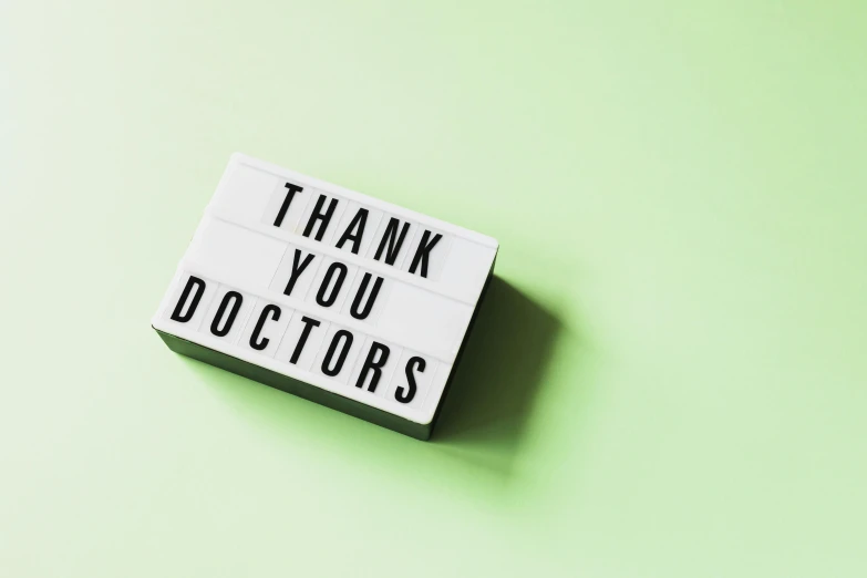 a sign that says thank you doctors on a green background, a picture, shutterstock, on grey background, lightbox, kaethe butcher, celebrities